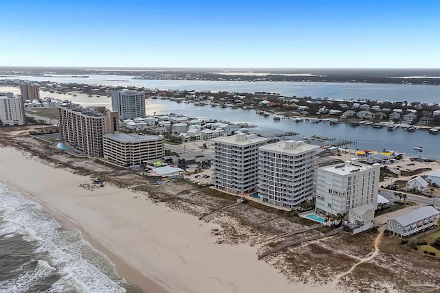 drone / aerial view with a water view and a beach view