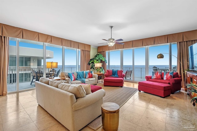 living room with ceiling fan and light tile patterned floors