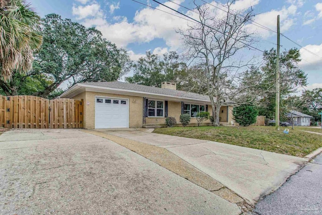 single story home featuring a garage and a front yard