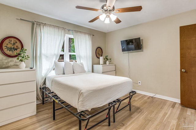 bedroom with ceiling fan and light wood-type flooring