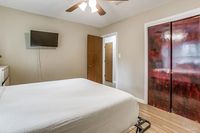 bedroom with light hardwood / wood-style floors and ceiling fan