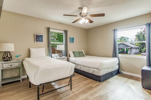 bedroom with ceiling fan and light wood-type flooring