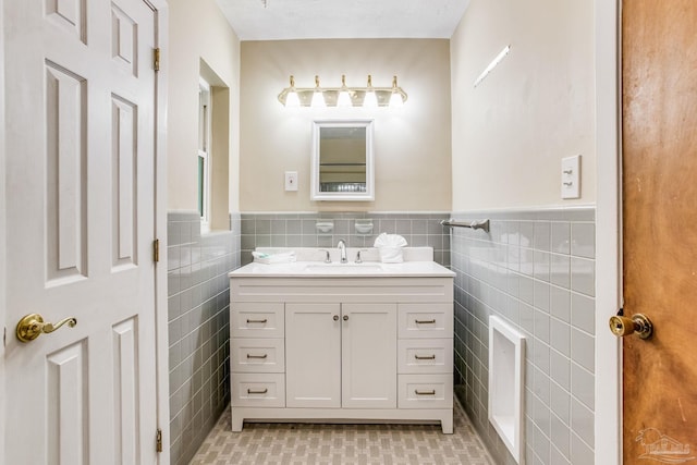 bathroom featuring tile walls and vanity