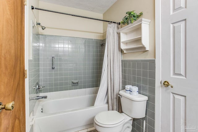 bathroom with tile walls, a textured ceiling, toilet, and shower / bath combo