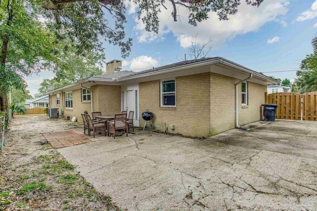 back of property with a patio area and central air condition unit