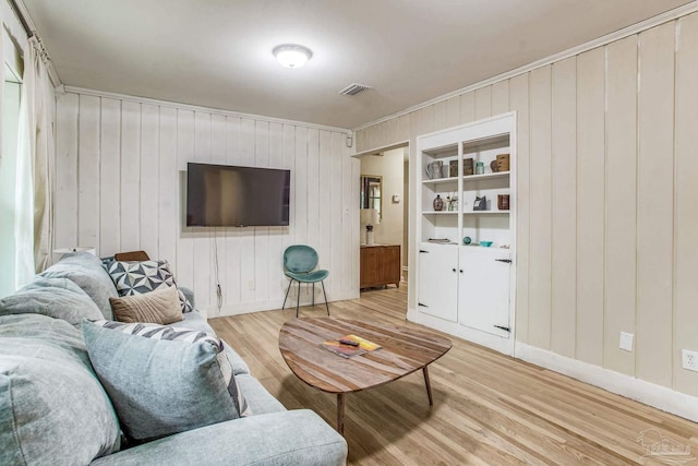 living room with crown molding and hardwood / wood-style flooring