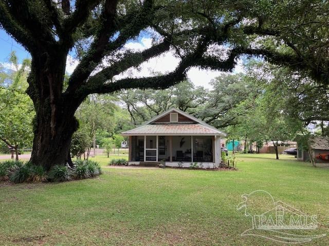 4316 Floridatown Rd, Pace, FL 32571 - back of house with a sunroom and a lawn