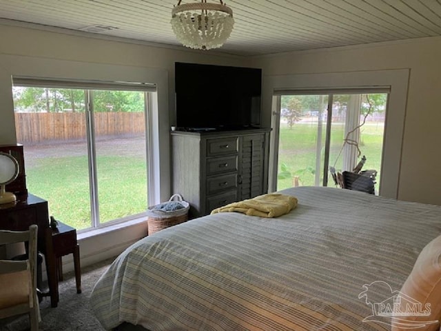 4316 Floridatown Rd, Pace, FL 32571 - bedroom with access to exterior, multiple windows, crown molding, and a chandelier