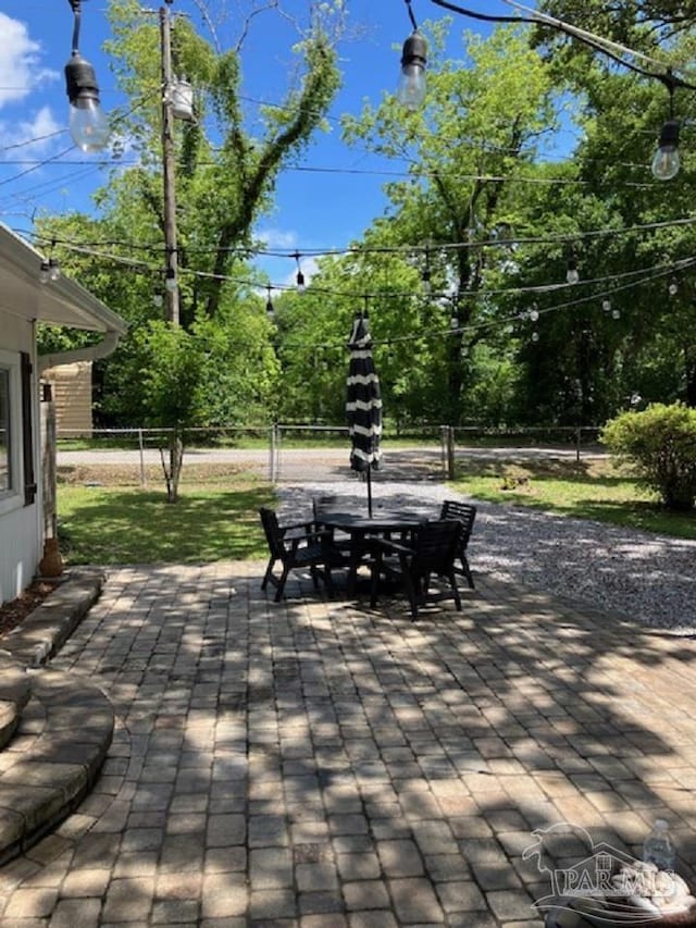 4316 Floridatown Rd, Pace, FL 32571 - view of patio / terrace featuring outdoor dining area, fence, and view of scattered trees