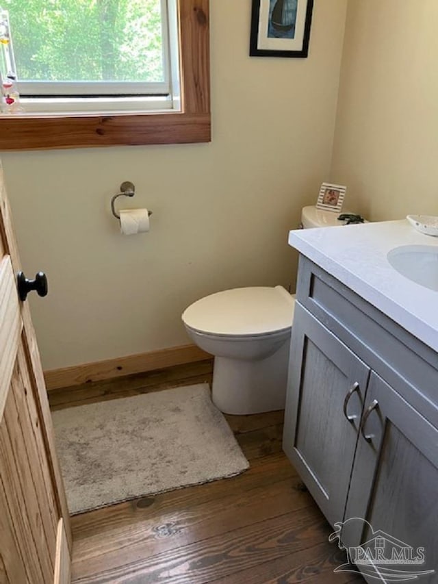 4316 Floridatown Rd, Pace, FL 32571 - bathroom featuring toilet, vanity, wood finished floors, and baseboards