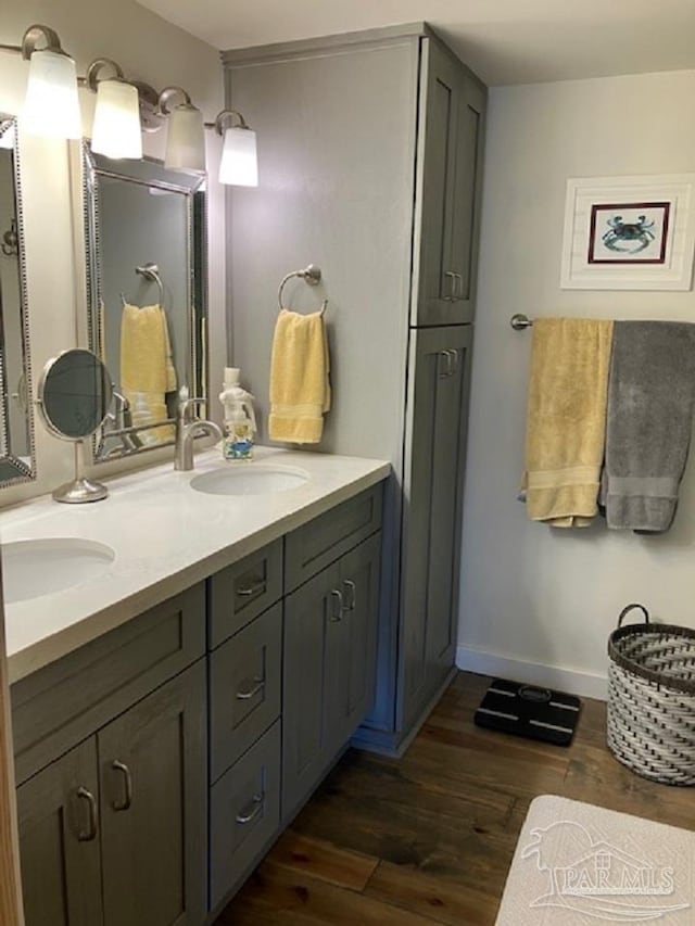 4316 Floridatown Rd, Pace, FL 32571 - full bathroom with wood finished floors, double vanity, and baseboards