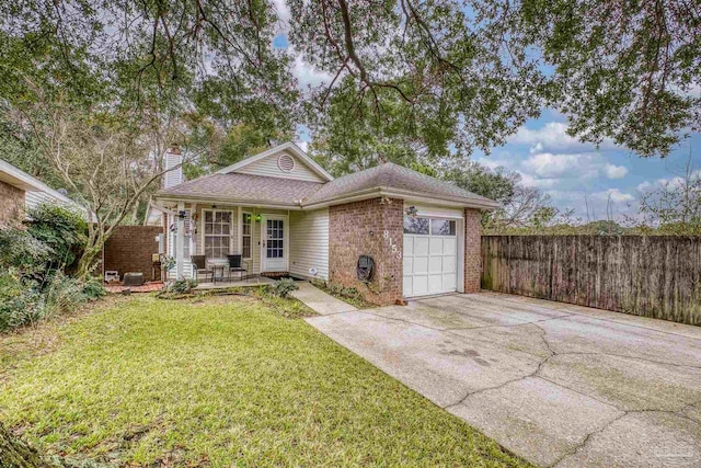 ranch-style house featuring a garage, covered porch, and a front yard