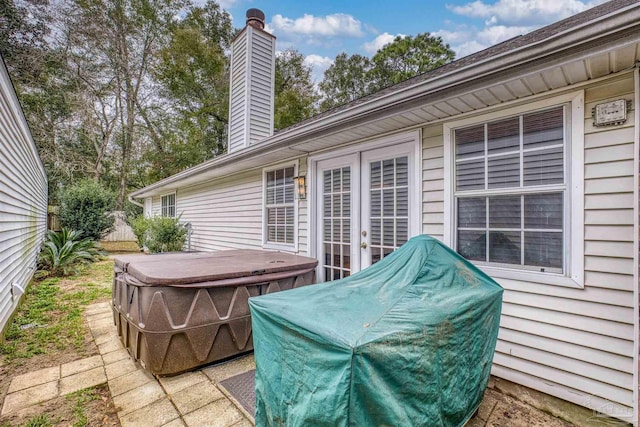 view of patio / terrace with french doors and a hot tub