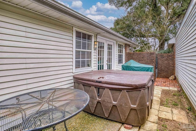 view of patio featuring a hot tub and french doors