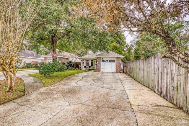 ranch-style house featuring a garage and a front lawn