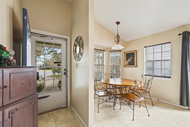 tiled dining area featuring lofted ceiling