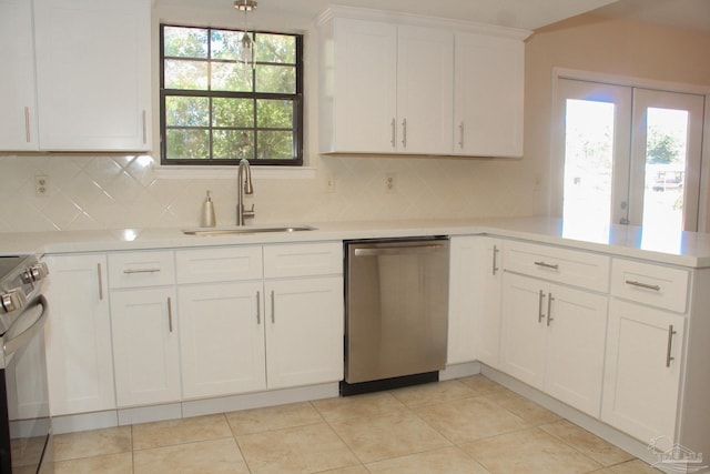 kitchen featuring dishwasher, electric range oven, tasteful backsplash, and sink