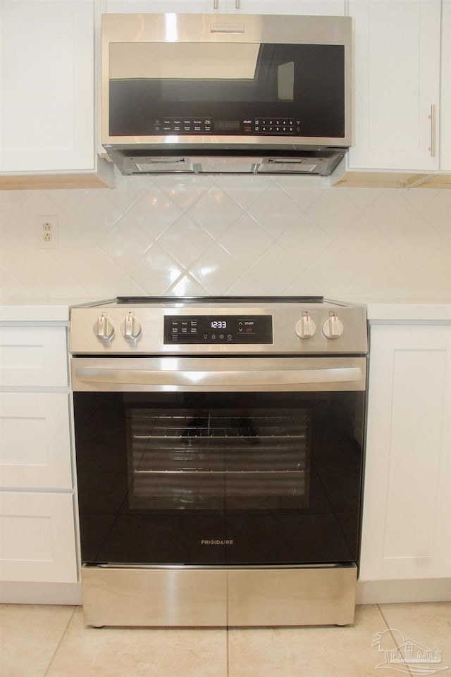 interior details featuring white cabinets and stainless steel appliances