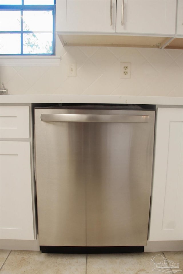 interior details with white cabinetry and stainless steel dishwasher