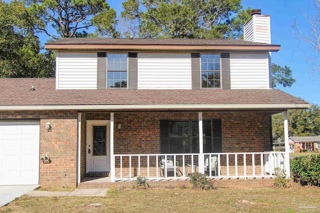 view of property featuring a porch and a garage