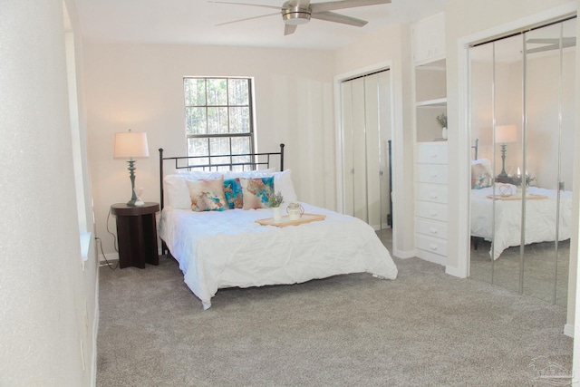 bedroom with multiple closets, ceiling fan, and carpet floors