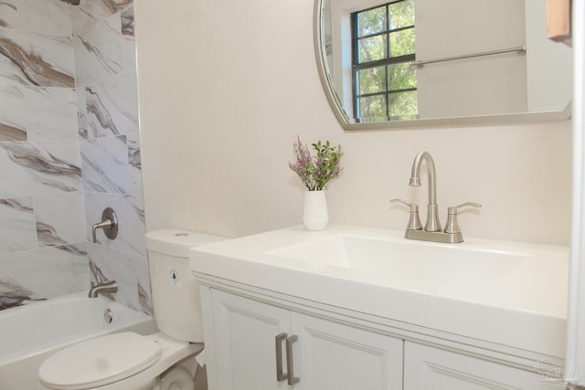 full bathroom with vanity, tiled shower / bath combo, and toilet