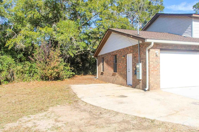 view of side of home with a garage