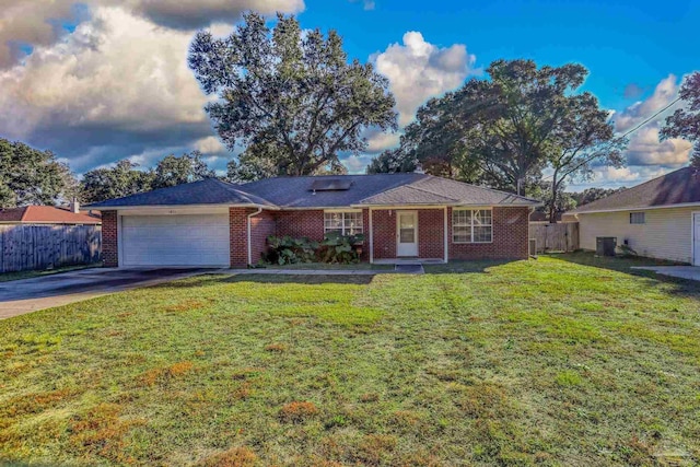 ranch-style home featuring a garage and a front lawn