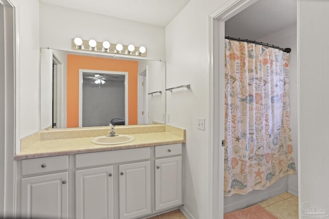 bathroom with tile patterned floors, vanity, a textured ceiling, and shower / tub combo