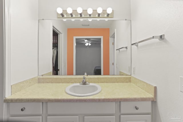 bathroom with ceiling fan and vanity