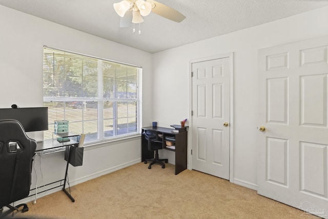 carpeted home office featuring a wealth of natural light and ceiling fan