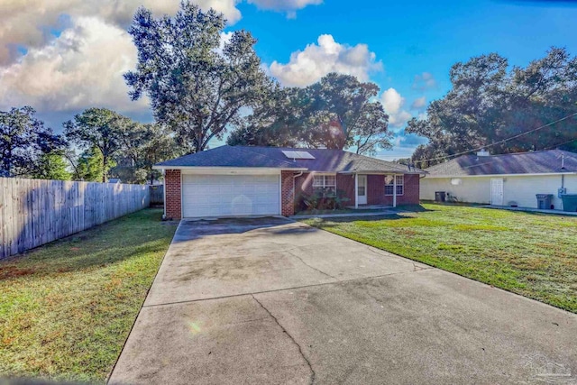 ranch-style home featuring a garage and a front lawn