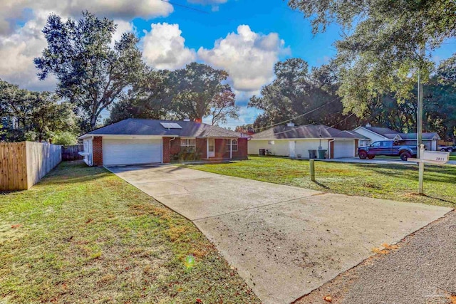 single story home featuring a garage and a front yard