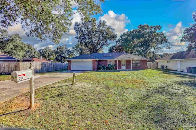 ranch-style house featuring a front yard and a garage