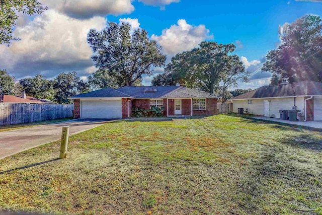 ranch-style house featuring a garage and a front lawn