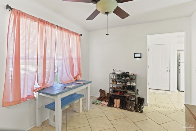 miscellaneous room featuring ceiling fan, a healthy amount of sunlight, and light tile patterned floors