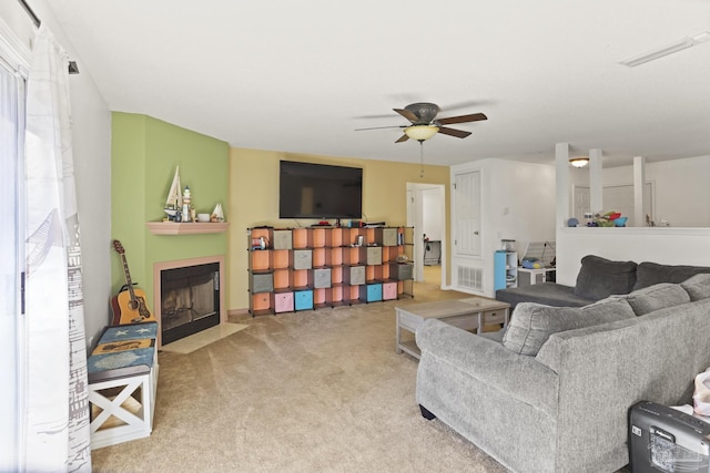 carpeted living room with ceiling fan