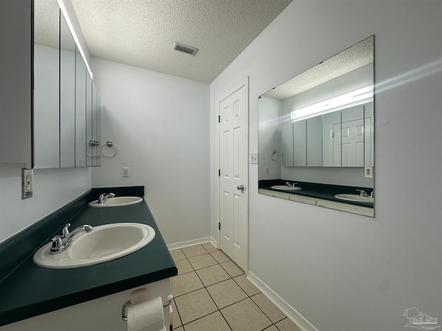 4885 Mayo Cir, Pace, FL 32571 - full bathroom featuring a textured ceiling, double vanity, and tile patterned floors