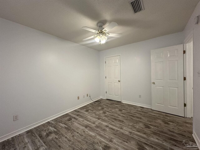4885 Mayo Cir, Pace, FL 32571 - unfurnished bedroom with dark wood-style floors, baseboards, and a textured ceiling