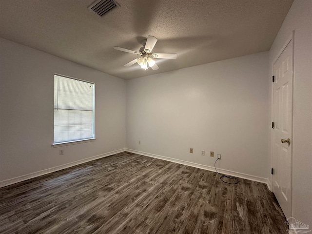 4885 Mayo Cir, Pace, FL 32571 - spare room featuring dark wood-type flooring, a textured ceiling, a ceiling fan, and baseboards