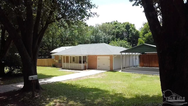 4885 Mayo Cir, Pace, FL 32571 - back of property featuring a detached carport, driveway, and a garage