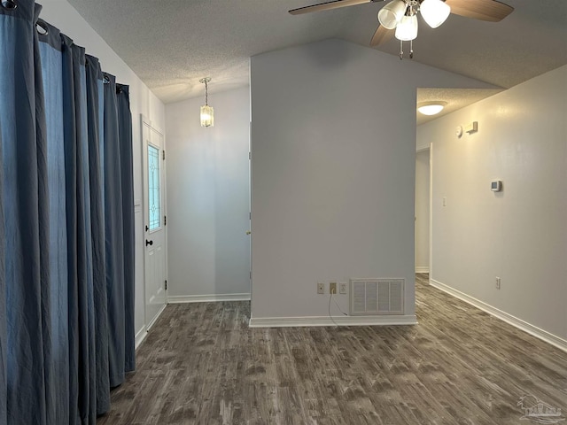 4885 Mayo Cir, Pace, FL 32571 - spare room featuring vaulted ceiling, dark wood-style floors, a ceiling fan, baseboards, and a textured ceiling