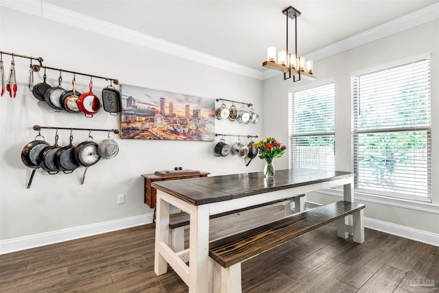 dining room with crown molding, dark wood-type flooring, and an inviting chandelier