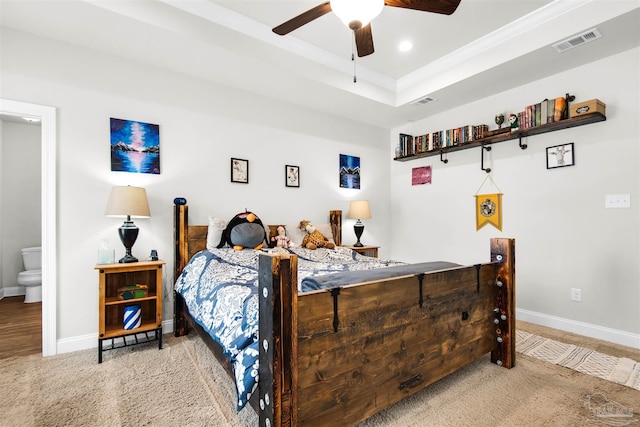 carpeted bedroom with connected bathroom and ceiling fan