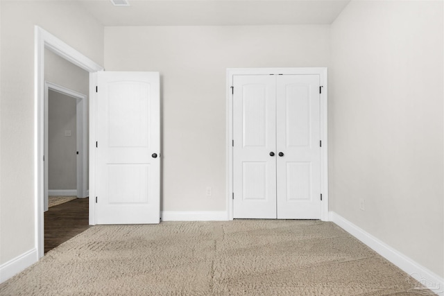 unfurnished bedroom featuring a closet and carpet floors