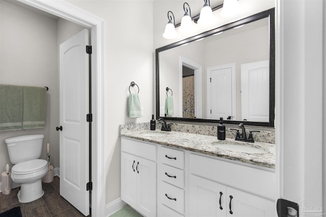 bathroom with hardwood / wood-style floors, vanity, and toilet