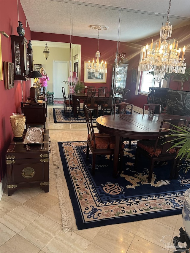 dining room featuring a notable chandelier and a textured ceiling