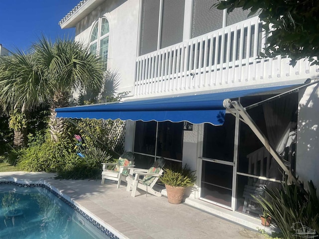 view of swimming pool with a patio