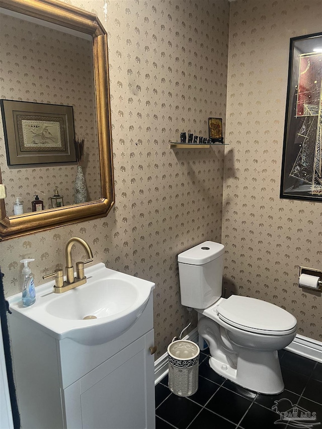 bathroom with vanity, tile patterned floors, and toilet