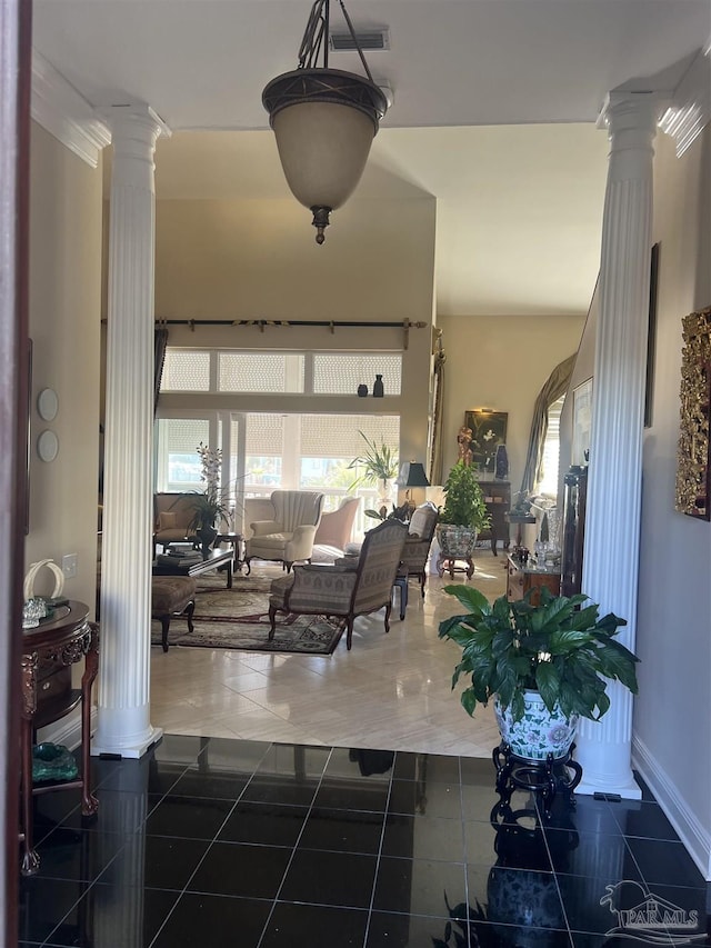 living room featuring dark tile patterned floors and ornate columns